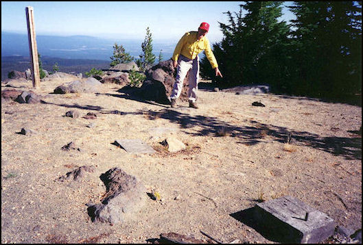 The flagstone landing that Richard Spray points to in the photo is all but invisible unless you are directly above it. The marker post is on the left. Two of the foundation blocks are in the foreground.